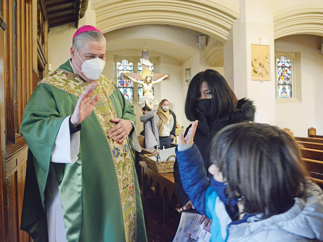 Bishop-elect John Bonnici greets a young parishioner at St. Augustine’s Church in Larchmont Feb. 6.