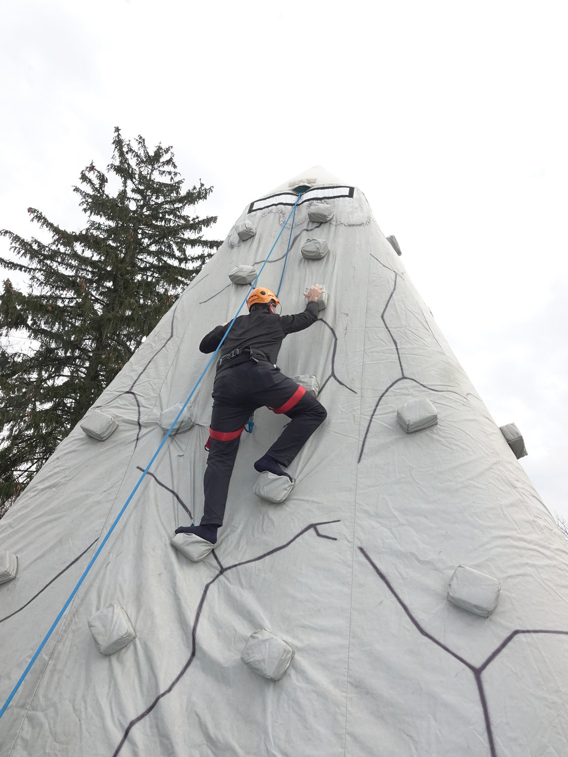 Father George Sears, archdiocesan director of vocations, climbs a rock wall after Mass at St. Joseph’s Day for Vocations held on the Feast of St. Joseph, March 19, at St. Joseph’s Seminary in Dunwoodie.