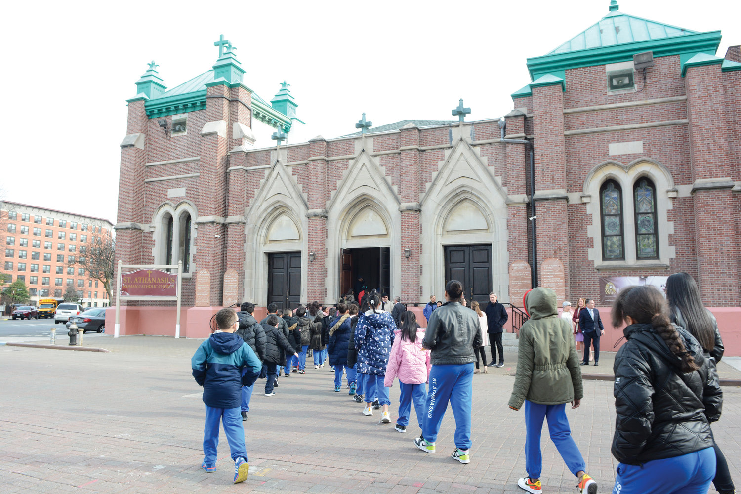 Students from St. Athanasius School, the Bronx, walk to nearby St. Athanasius Church where Cardinal Dolan offered morning Mass for them March 23 before touring the school.