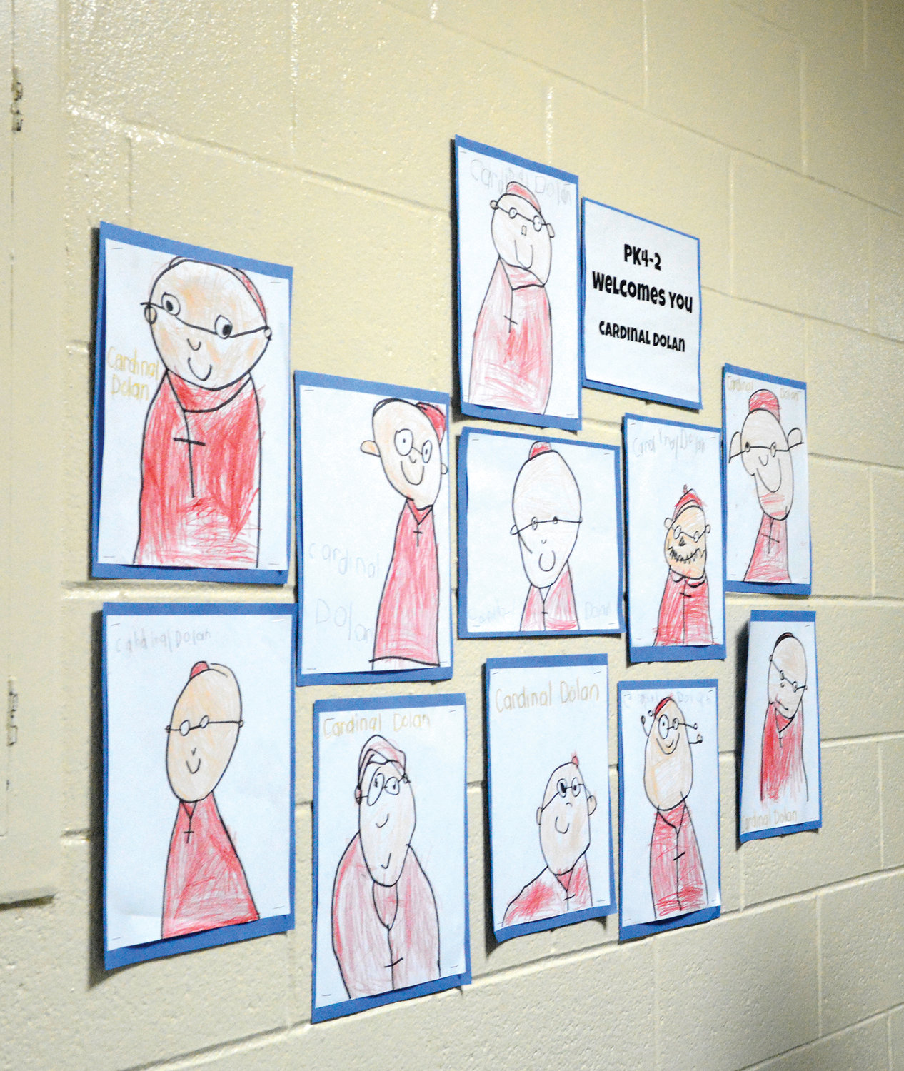 Creative renderings of Cardinal Dolan by artistic youngsters grace a hallway wall at the school.
