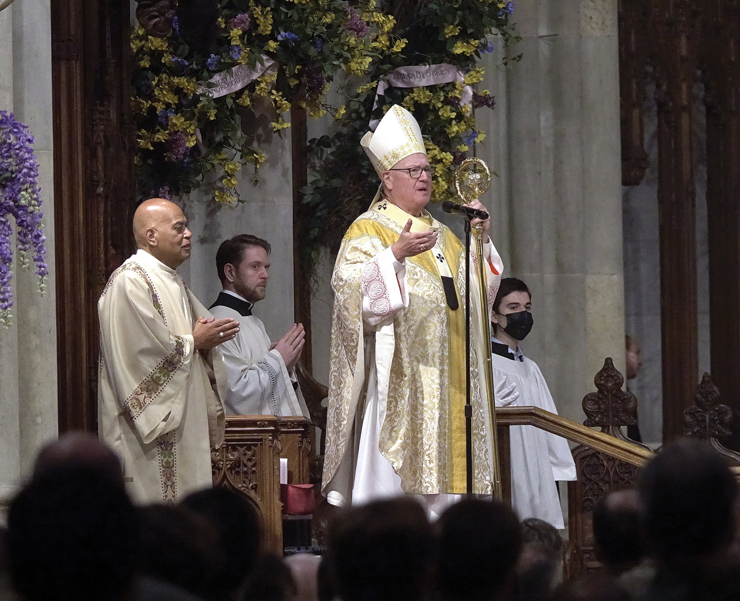 Precious flowers, generously donated in the name of Cardinal Dolan’s late parents, gracefully frame the cathedra at St. Patrick’s Cathedral during the 10 a.m. Mass the cardinal celebrated on Easter Sunday, April 17.