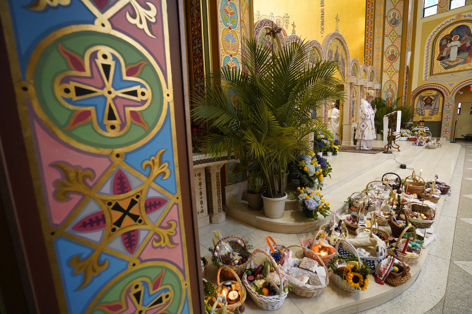 Easter baskets are seen near the sanctuary as Bishop Paul P. Chomnycky of the Ukrainian Catholic Eparchy of Stamford, Conn. celebrates an Easter Divine Liturgy April 24 at St. George Ukrainian Catholic Church in Manhattan’s East Village.