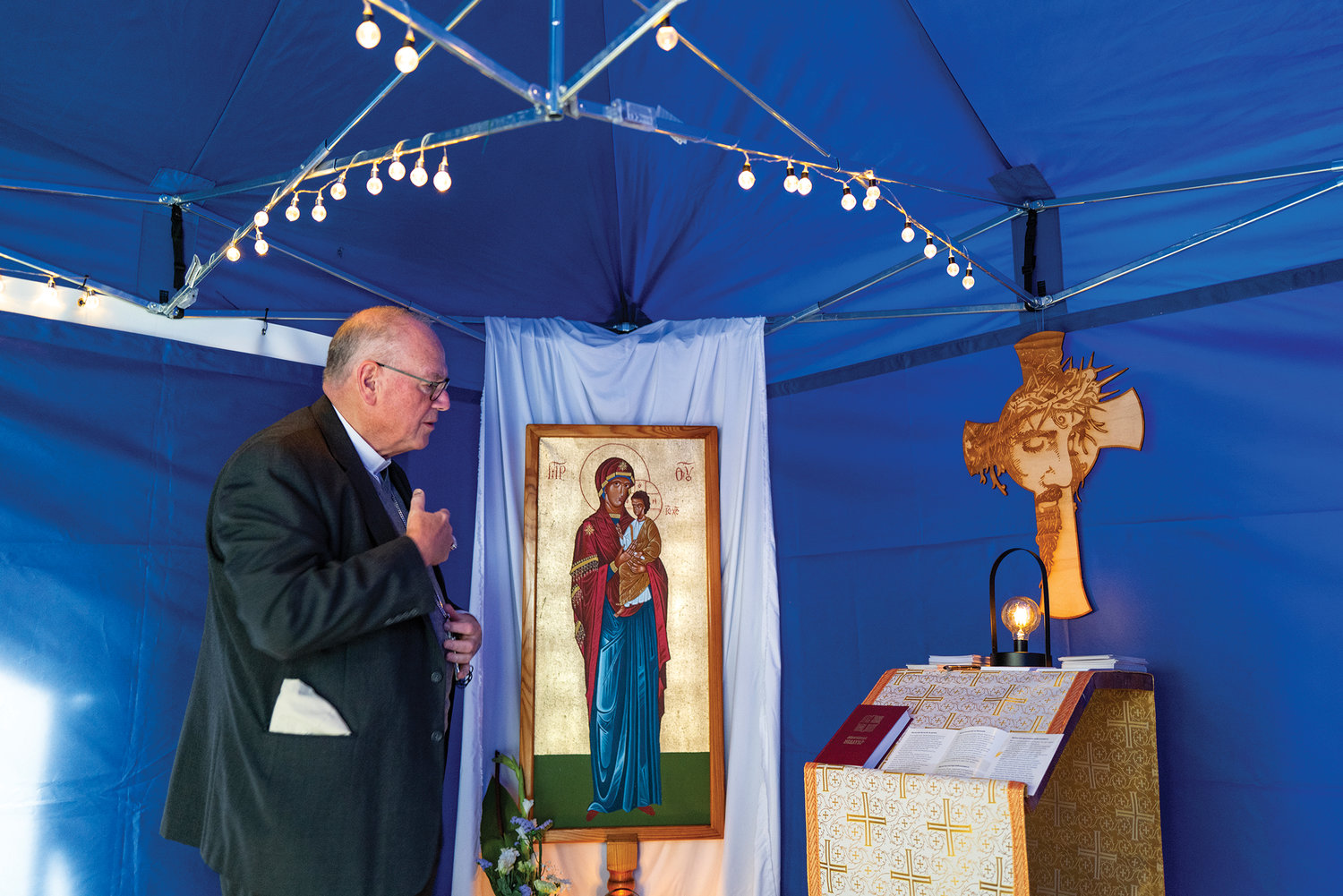 Cardinal Dolan prays April 30 in a makeshift chapel in the train station at Kosice, Slovakia, where thousands of Ukrainian refugees have arrived since their country’s invasion by Russia.