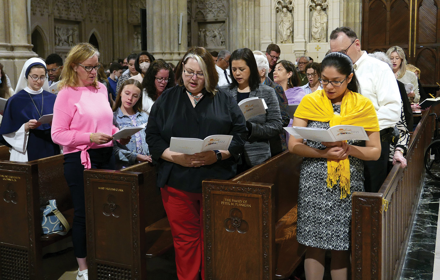 SHARED MISSION—Congregants assemble for the Synodal Unity Mass of Thanksgiving Cardinal Dolan celebrated May 15 at St. Patrick’s Cathedral. The Synod’s local leadership includes Elizabeth Guevara de Gonzalez, director of the archdiocesan Office of Adult Faith Formation, far right in yellow shawl. Next to Ms. de Gonzalez is Ela Milewska, executive director of the Department of Youth Faith Formation.