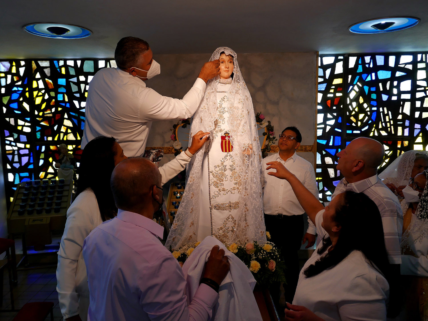 A new Our Lady of Mercy statue was featured during the May 1 Mass honoring Mary under that title at Holy Cross parish in the Bronx. Parishioners tend to the statue’s veil. Our Lady of Mercy is patroness of Spain, the Dominican Republic and other Latin American countries. Holy Cross parish has a large Dominican population.