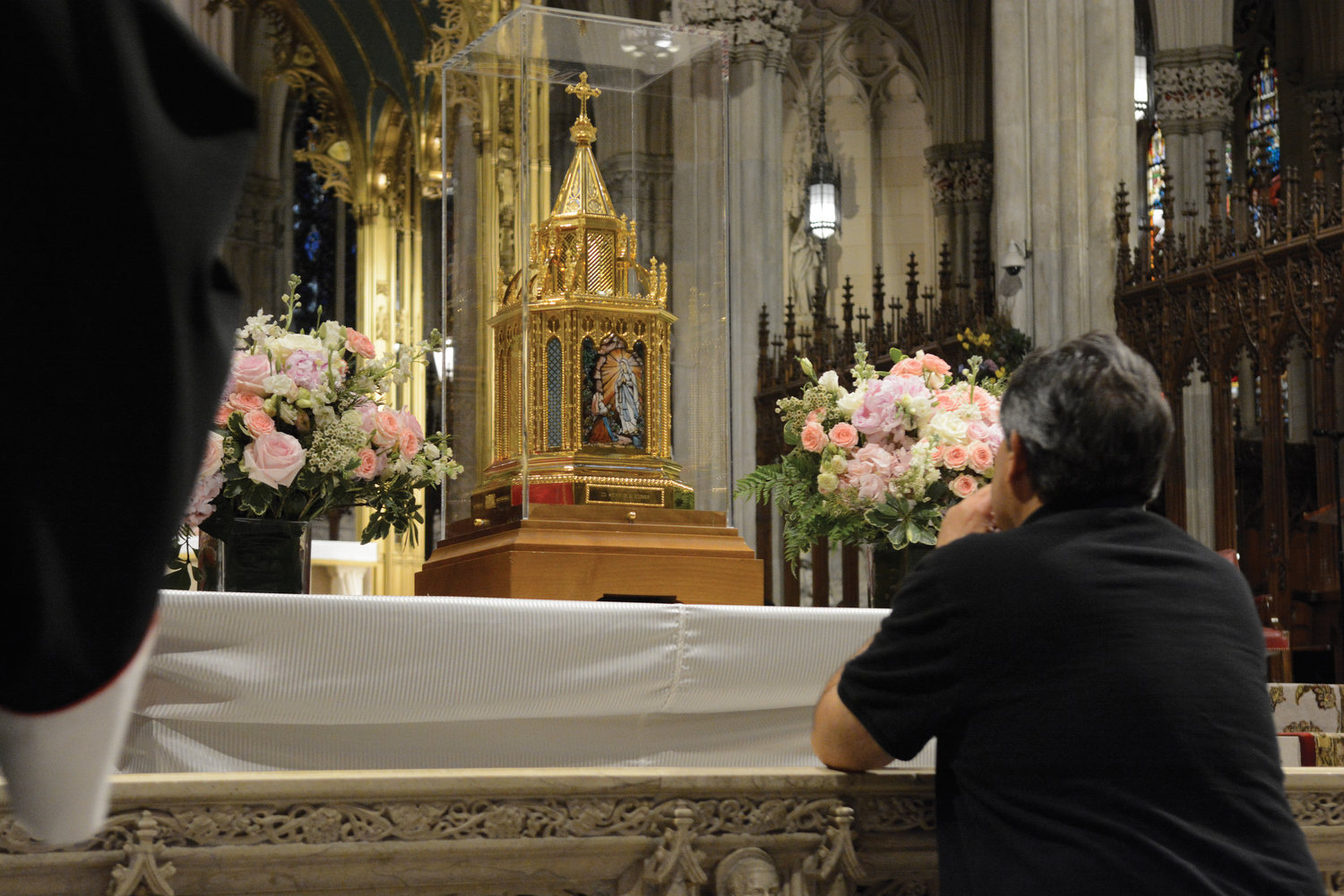 RELICS OF ST. BERNADETTE—A man prays before a reliquary containing relics of St. Bernadette of Lourdes May 23 at St. Patrick’s Cathedral. Relics of St. Bernadette are currently touring the United States for the first time. The pilgrimage will continue with cross-country stops through Aug. 4, with the last visit scheduled at St. Bernadette Church in Los Angeles. The Manhattan stop included a five-day visit to Our Lady of Lourdes Church in Harlem.