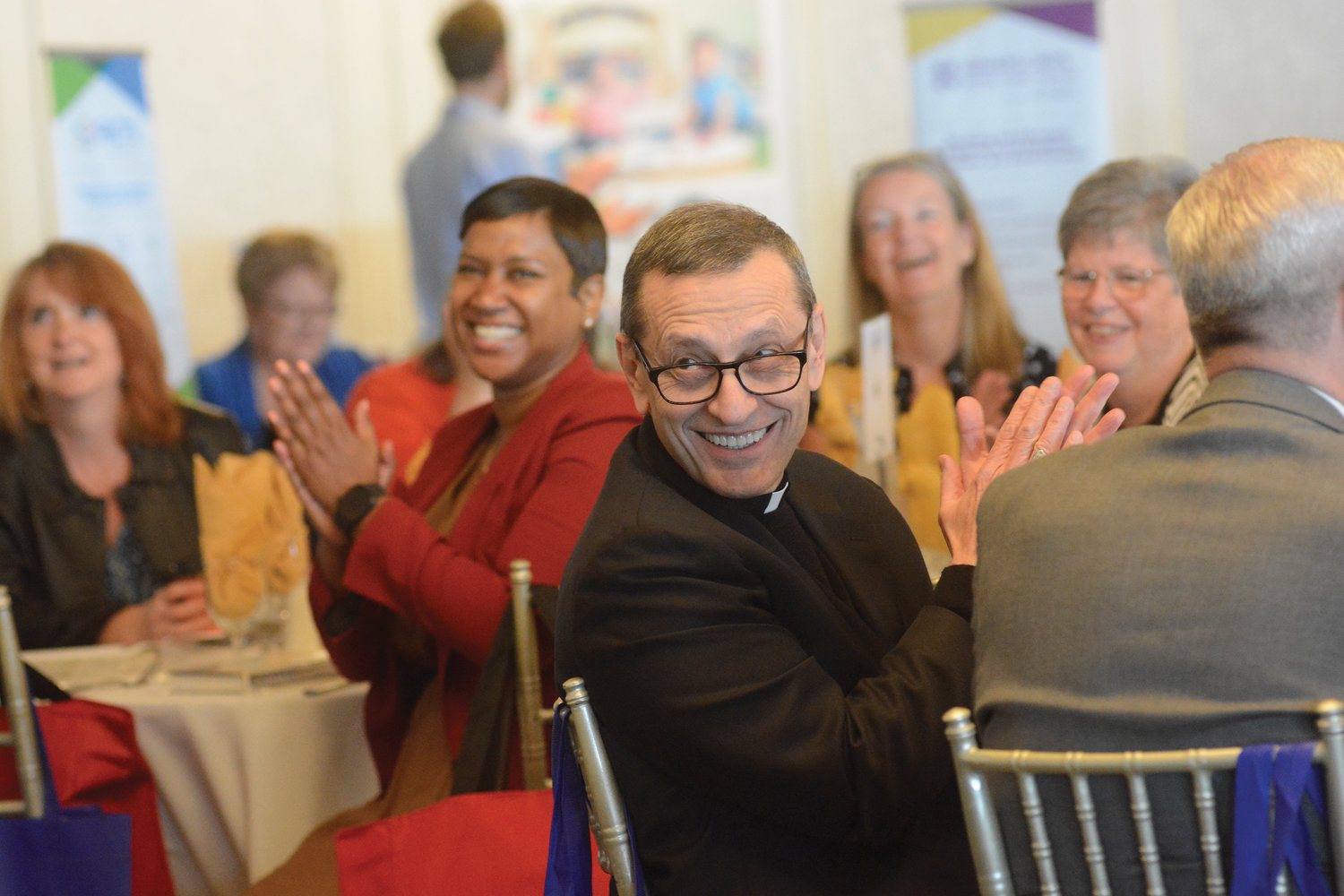 Bishop Frank Caggiano of the Diocese of Bridgeport, Conn., applauds May 25 during the spring principals’ meeting at Marina del Rey in the Bronx, where he was the principal speaker.