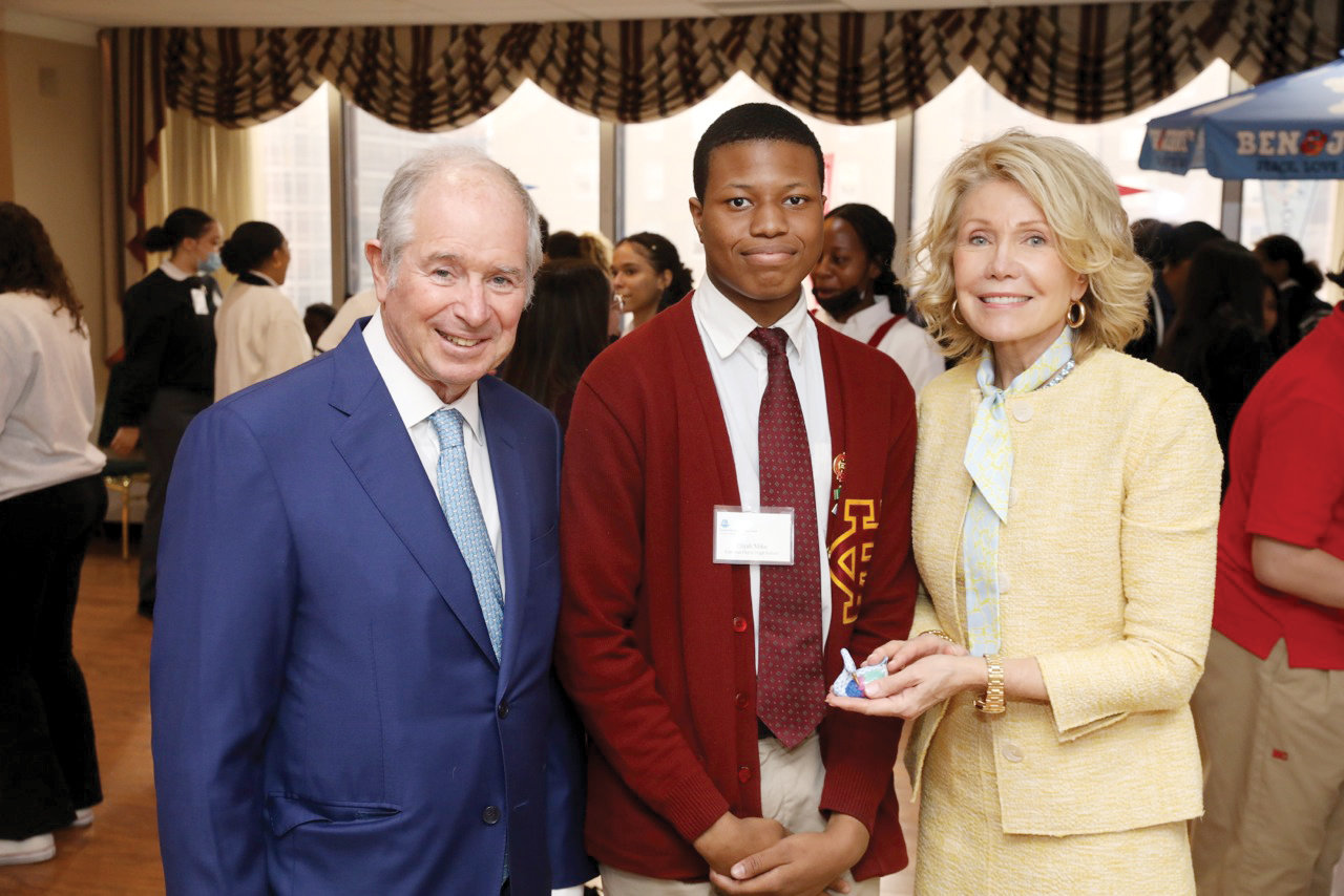Cardinal Hayes High School senior Elijah Mike, center, joins Stephen and Christine Schwarzman at the celebration for high school seniors at Dillon Hall in the New York Catholic Center in Manhattan May 17. Mike plans to study at Sophie Davis School of Biomedical Education where he hopes to earn a doctorate in medicine.