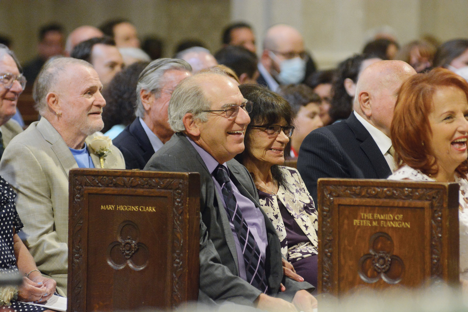 Couples enjoy the homily given by Cardinal Dolan.