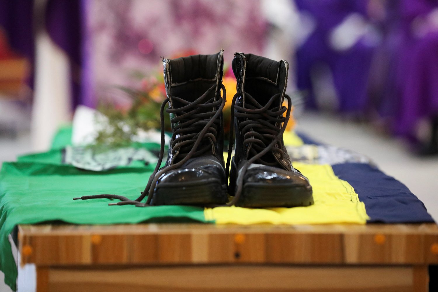 Police boots symbolizing a dead police officer are placed on a coffin during a Funeral Mass in the parish hall of St. Francis Xavier Church in Owo, Nigeria, June 17.
