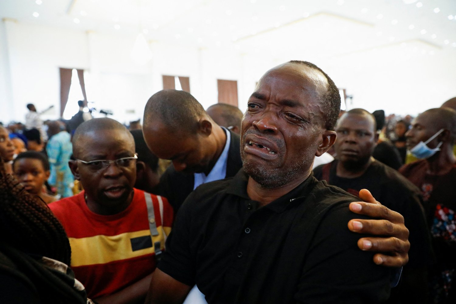 A man cries during a Funeral Mass in the parish hall of St. Francis Xavier Church in Owo, Nigeria, June 17.