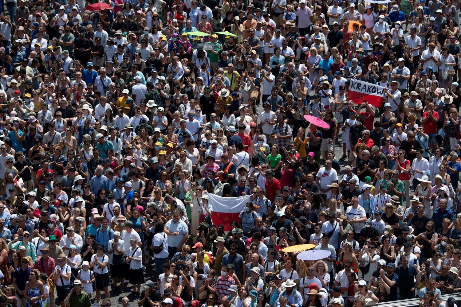 People in St. Peter’s Square attend the Angelus led by Pope Francis from the window of his studio overlooking the square at the Vatican June 19.