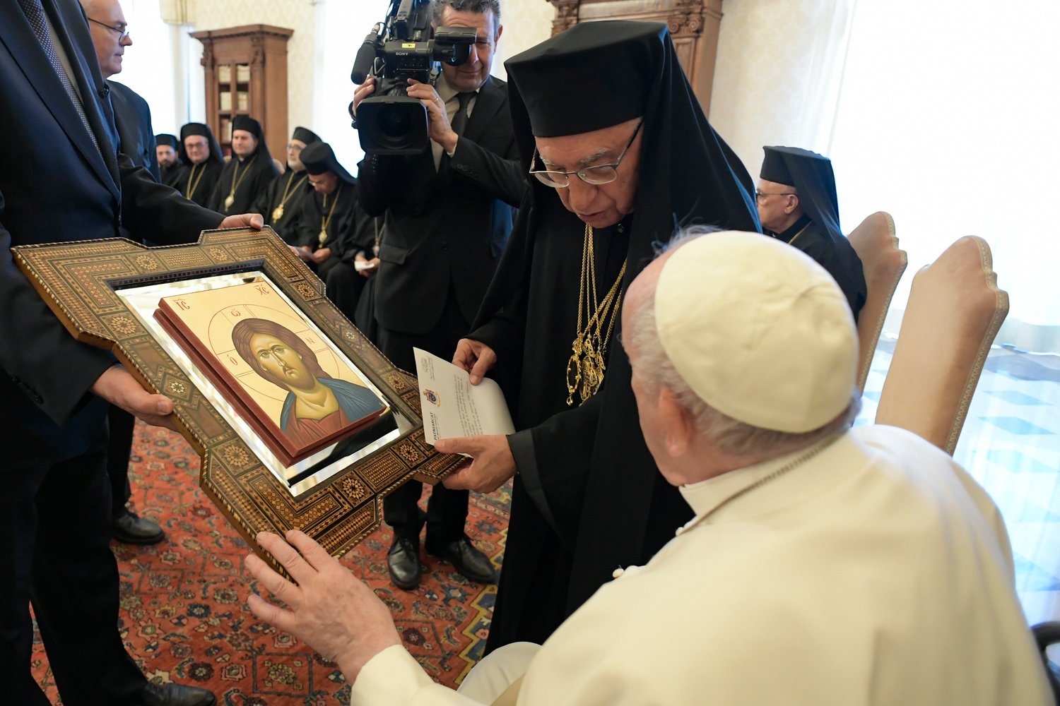 Pope Francis accepts an icon from Melkite Patriarch Joseph Absi during an audience with members of the synod of the Melkite Catholic Church at the Vatican June 20.