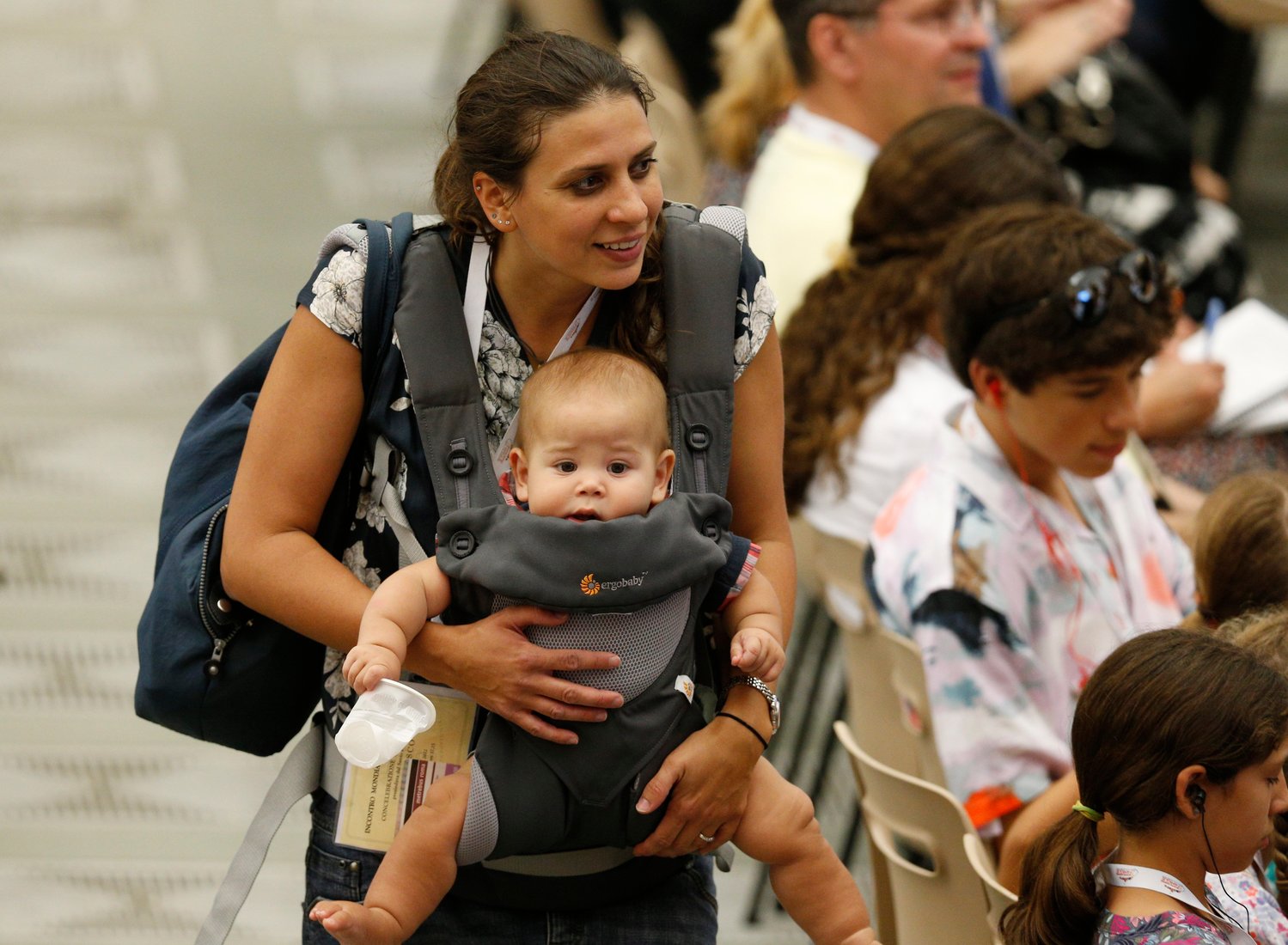 A woman carries a child during the World Meeting of Families in the Paul VI hall at the Vatican June 23.