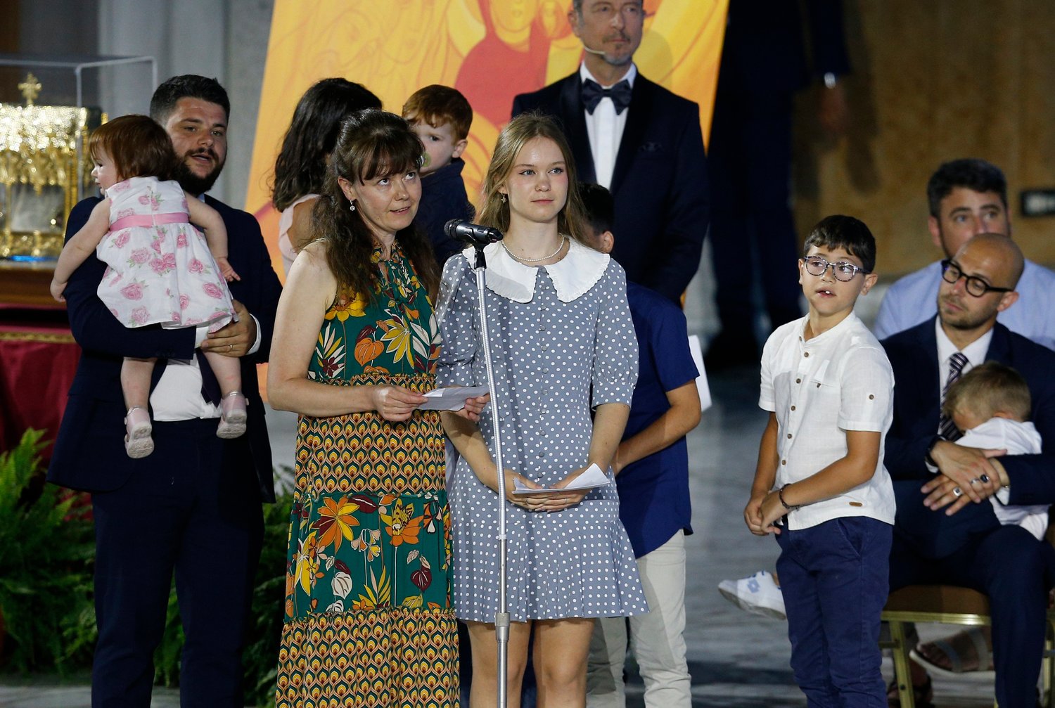 Iryna Kozhushko and her daughter, Sofia, from Ukraine, give their testimony as Pope Francis opens the World Meeting of Families in the Paul VI hall at the Vatican June 22. Pictured with them are Pietro and Erika Chiriaco, an Italian couple with six young children who are hosting them. The Festival of Families, an evening of sharing and music, was the opening event of the five-day meeting.