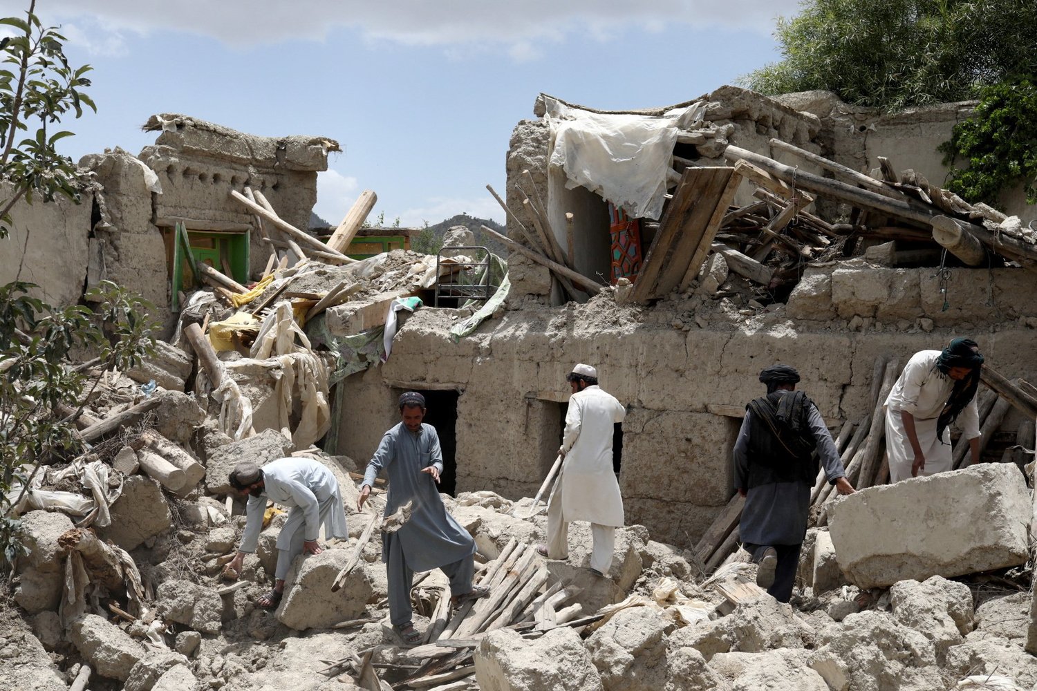 Afghan men search for survivors amid the debris of a destroyed house June 23 following an earthquake the previous day in Gayan, Afghanistan. During his June 22 general audience, Pope Francis offered prayers for victims of the magnitude 6 earthquake that hit a remote, mountainous area of Afghanistan near the border with Pakistan.