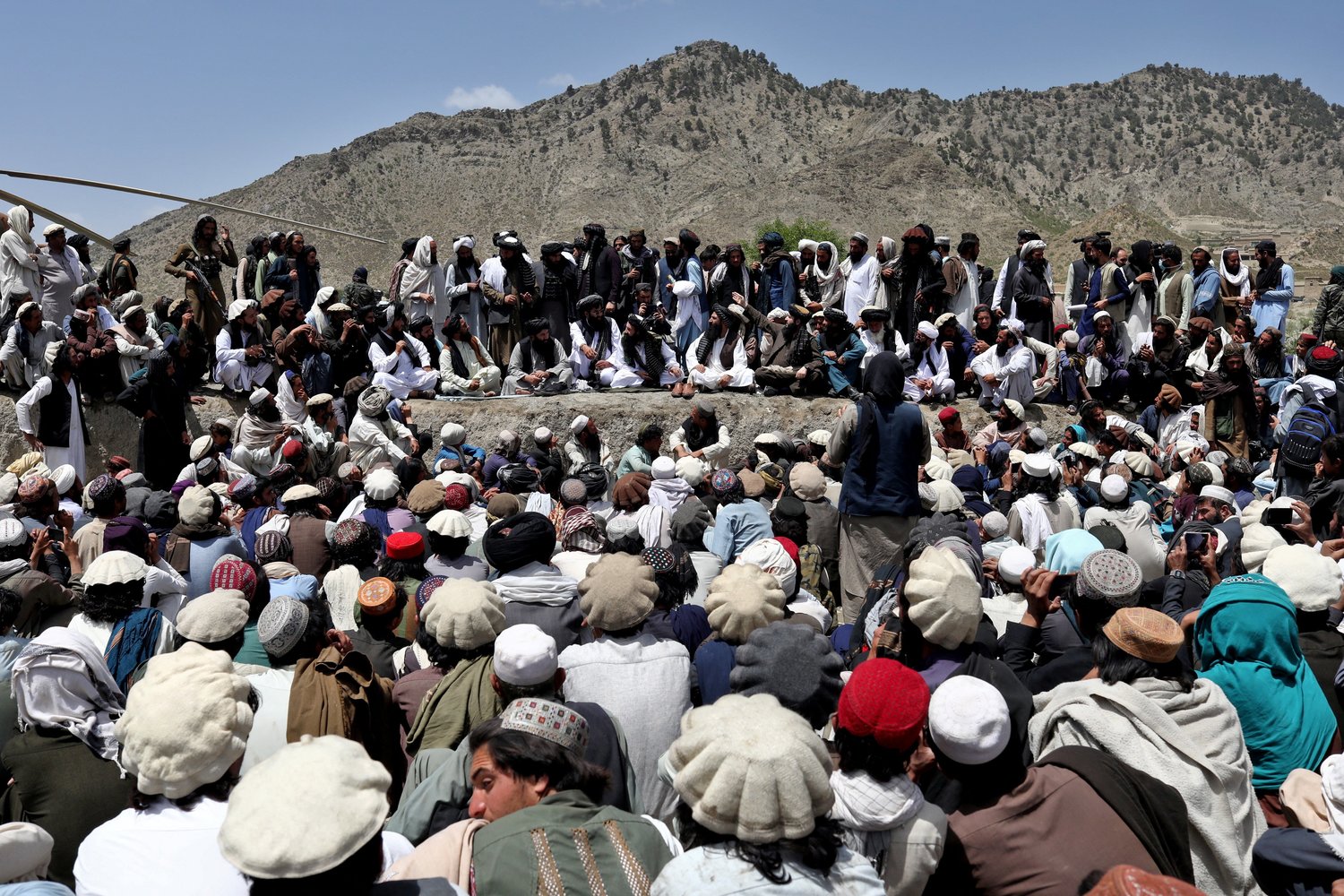 People wait for aid June 23 following an earthquake the previous day in Gayan, Afghanistan.