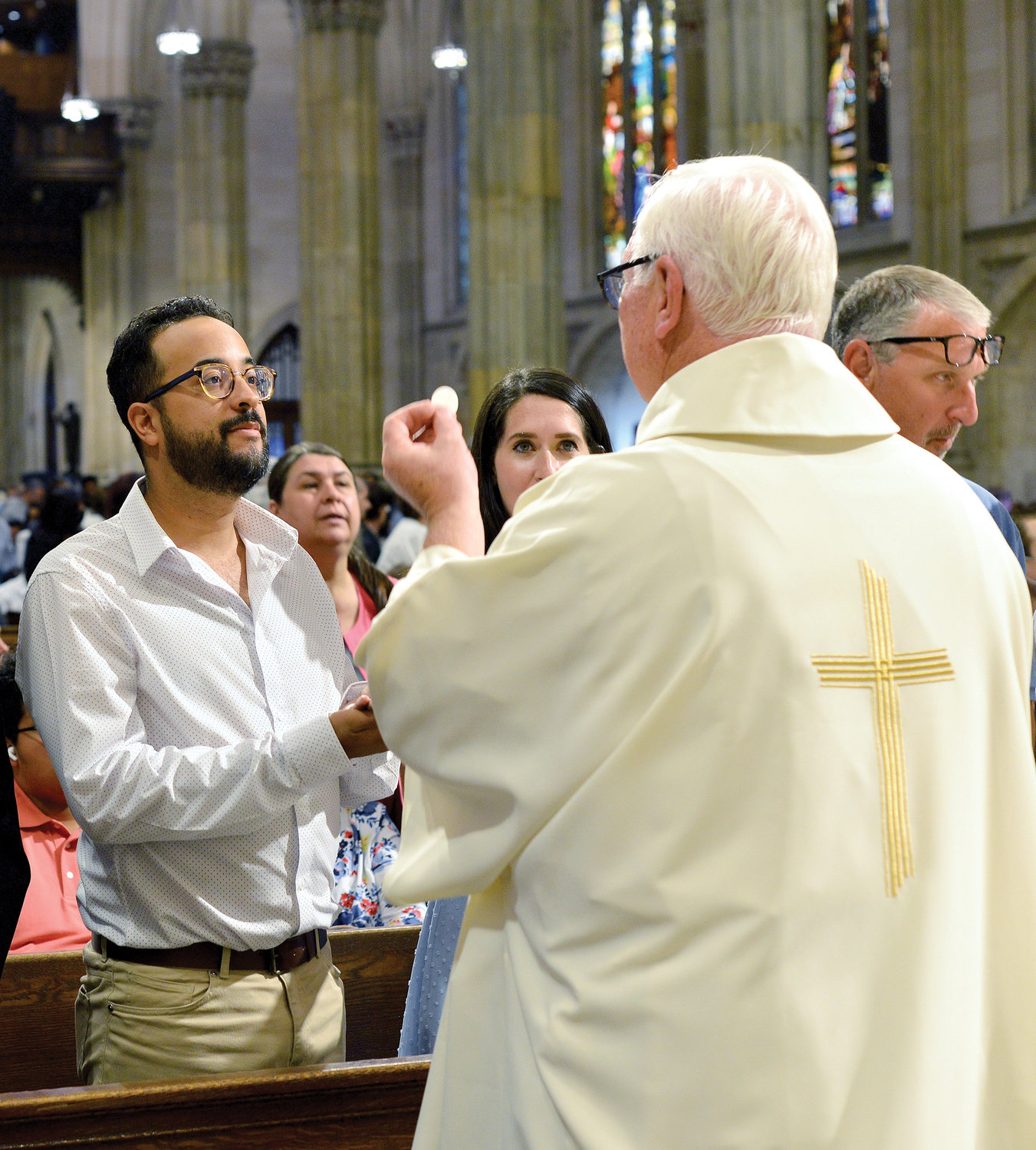 Deacon John Tremblay distributes Communion at the Mass of Ordination.