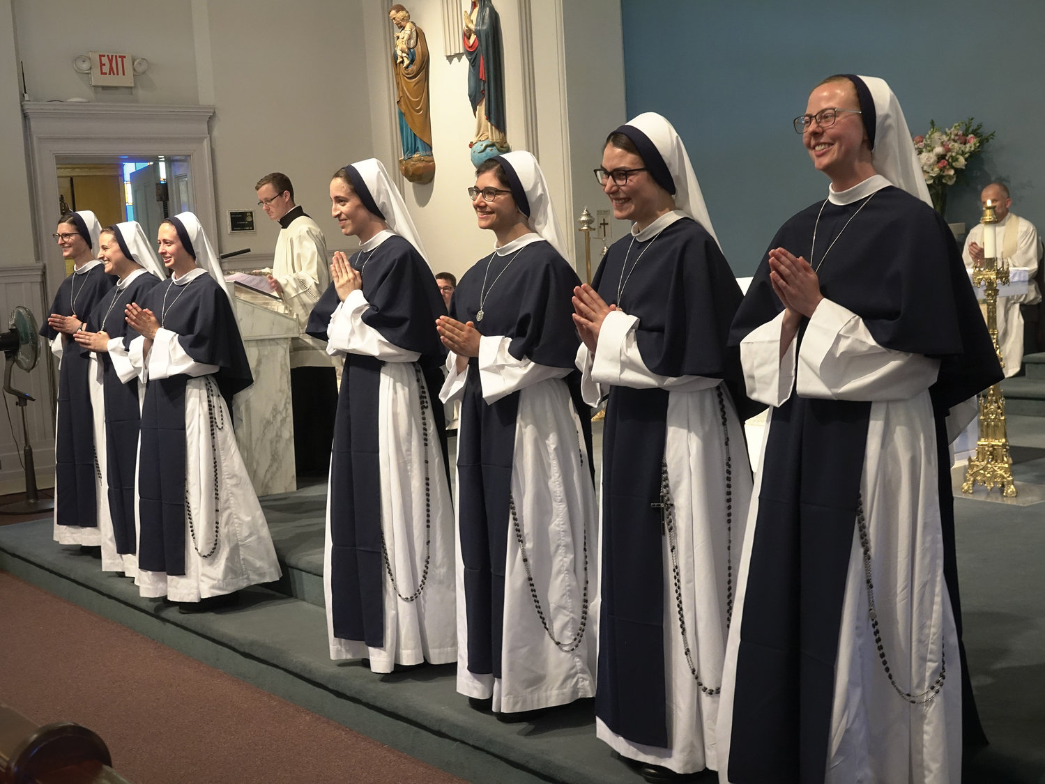 The seven Sisters of Life who made their first vows June 25 greet the faithful at Sacred Heart Church in Suffern. They were, from left: Sister Anne Marie Elizabeth, Sister Zion Joy, Sister Mary Hostia Josephine, Sister Caeli Gloriae, Sister Lilia Consolata, Sister Isabel Fiat Karolina and Sister Miriam Bethel.
