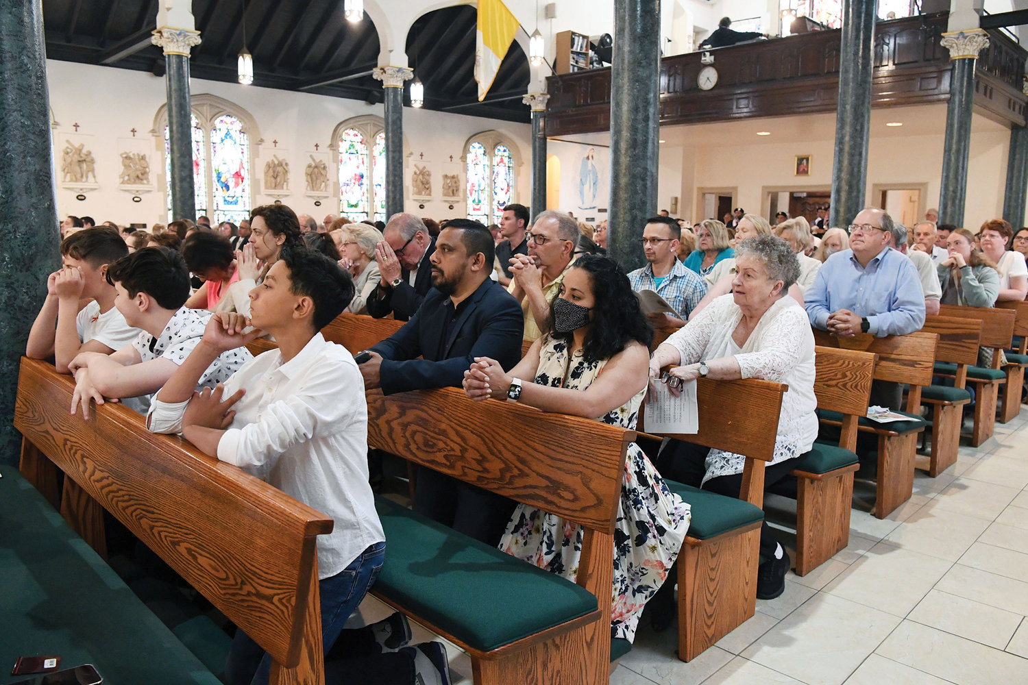 Parishioners fill the pews and prayerfully participate in the special Mass.