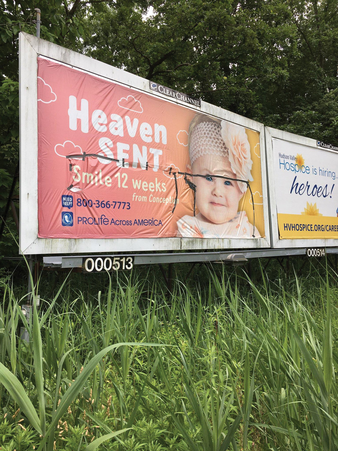 DEFACED—A pro-life billboard leased by the Ulster Deanery Respect Life Committee was damaged by vandals in Esopus overnight June 20-21. An attempt was made to patch the billboard as shown in the photo.