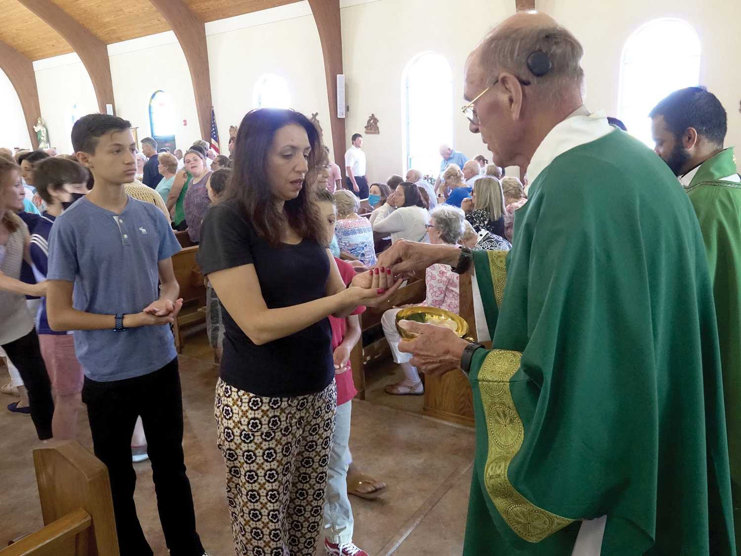 Deacon Robert Lyons distributes Communion.