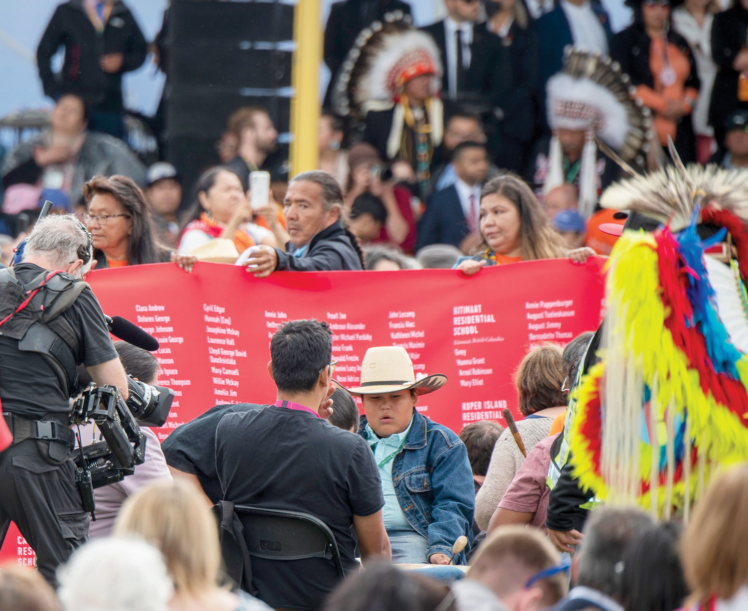 SAD TOLL—As the meeting with Pope Francis begins in Maskwacis, Alberta, July 25, Indigenous pilgrims carry a long red banner through the crowd. The banner bears the names of 4,120 Indigenous children and the residential school where they died.