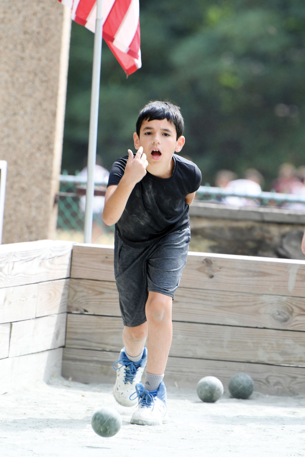 Max Stern, one of the youngest campers, tosses a bocce ball July 15 during competition at the Msgr. Farrell Bocce Summer Camp on Staten Island.