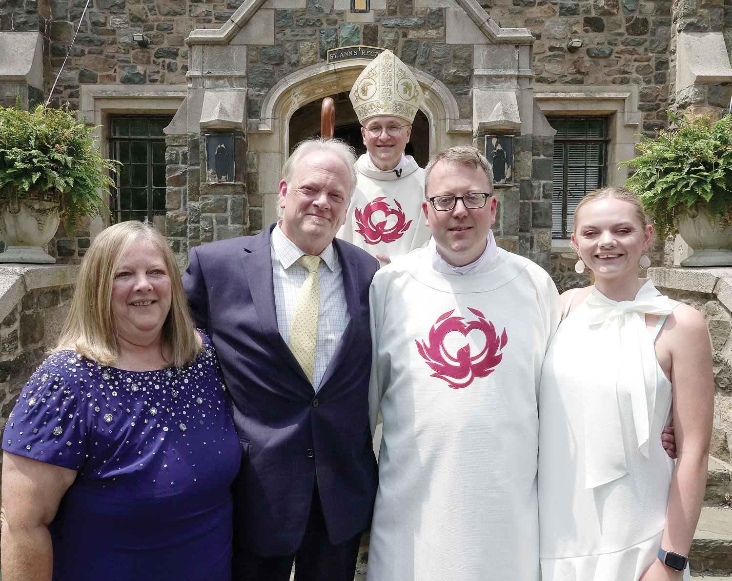Deacon Neier poses with his mother Patricia; father Bruce; Bishop Massa; and sister Caitlin.