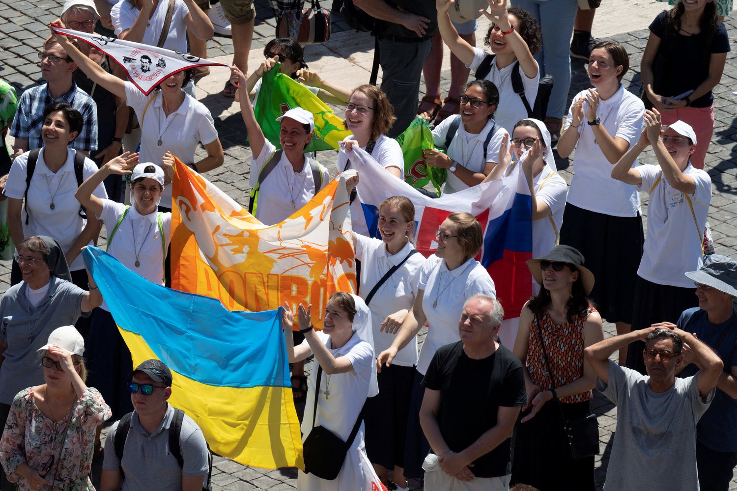 Nuns hold a Ukrainian flag as Pope Francis leads the Angelus from the window of his studio overlooking St. Peter’s Square at the Vatican July 31.