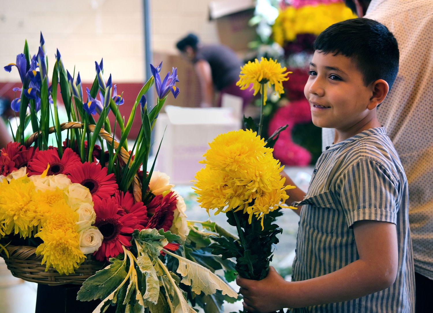 A boy helps with floral arrangements inside Santa Ana Ixtlahuatzingo Catholic Church in Tenancingo, Mexico, July 25.