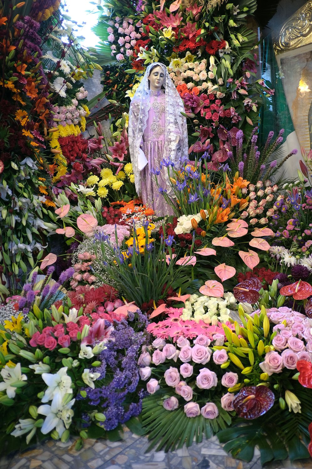 An image of Mary is pictured surrounded by floral arrangements inside Santa Ana Ixtlahuatzingo Catholic Church in Tenancingo, Mexico, July 26. The floral arrangements were for the feast of the church’s patron saint, St. Anne, Mary’s mother.