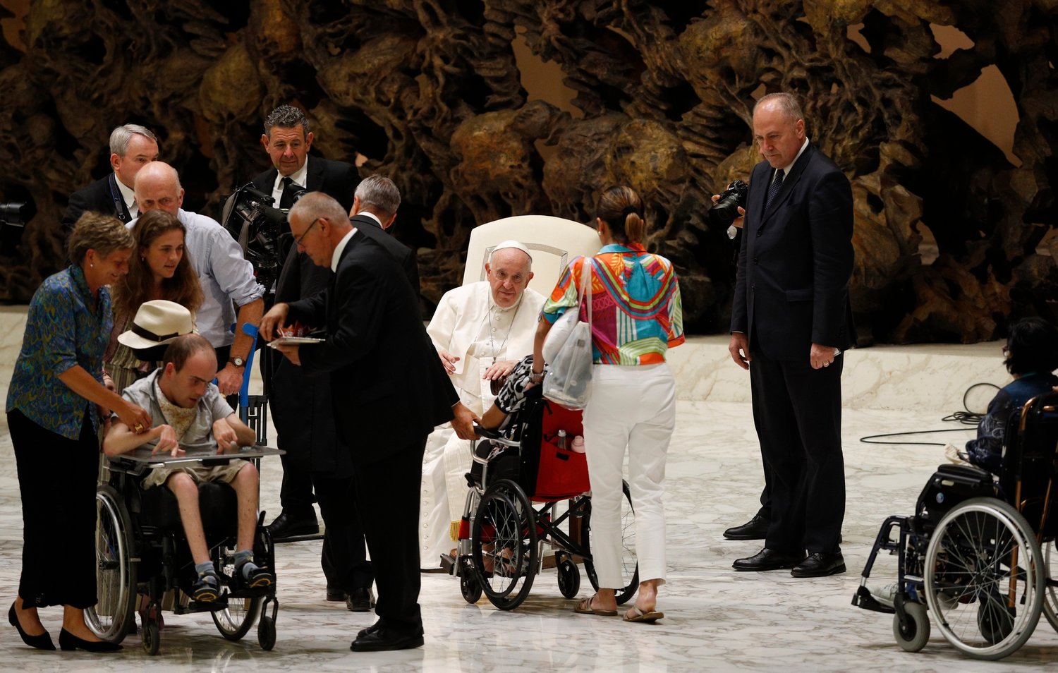 Pope Francis greets people in wheelchairs during his general audience in the Paul VI hall at the Vatican Aug. 3.