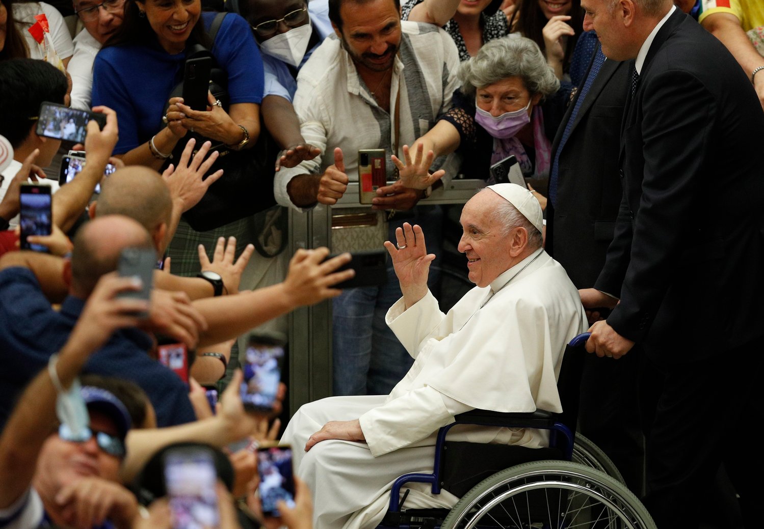Pope Francis greets the crowd as he leaves his general audience in the Paul VI hall at the Vatican Aug. 3.