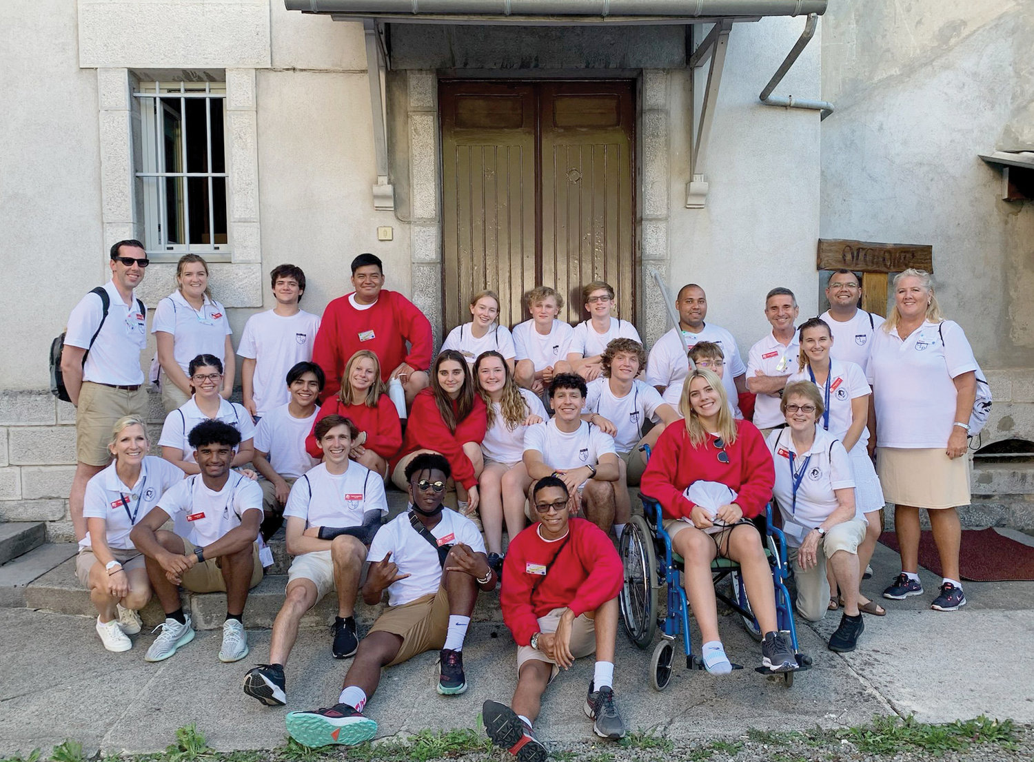 PILGRIMS IN LOURDES—In this group photo during the pilgrimage in Lourdes, France, Brother Bill Sherlog, C.F.C., stands third from right in the back row. In the front row, Hayes student Lucas Koon-Perez is seated second from left, and Hayes student Tylar Moore is fourth from left. The seven-day pilgrimage in late July was organized by Our Lady’s Pilgrimage, a nonprofit organization based in New Canaan, Conn.