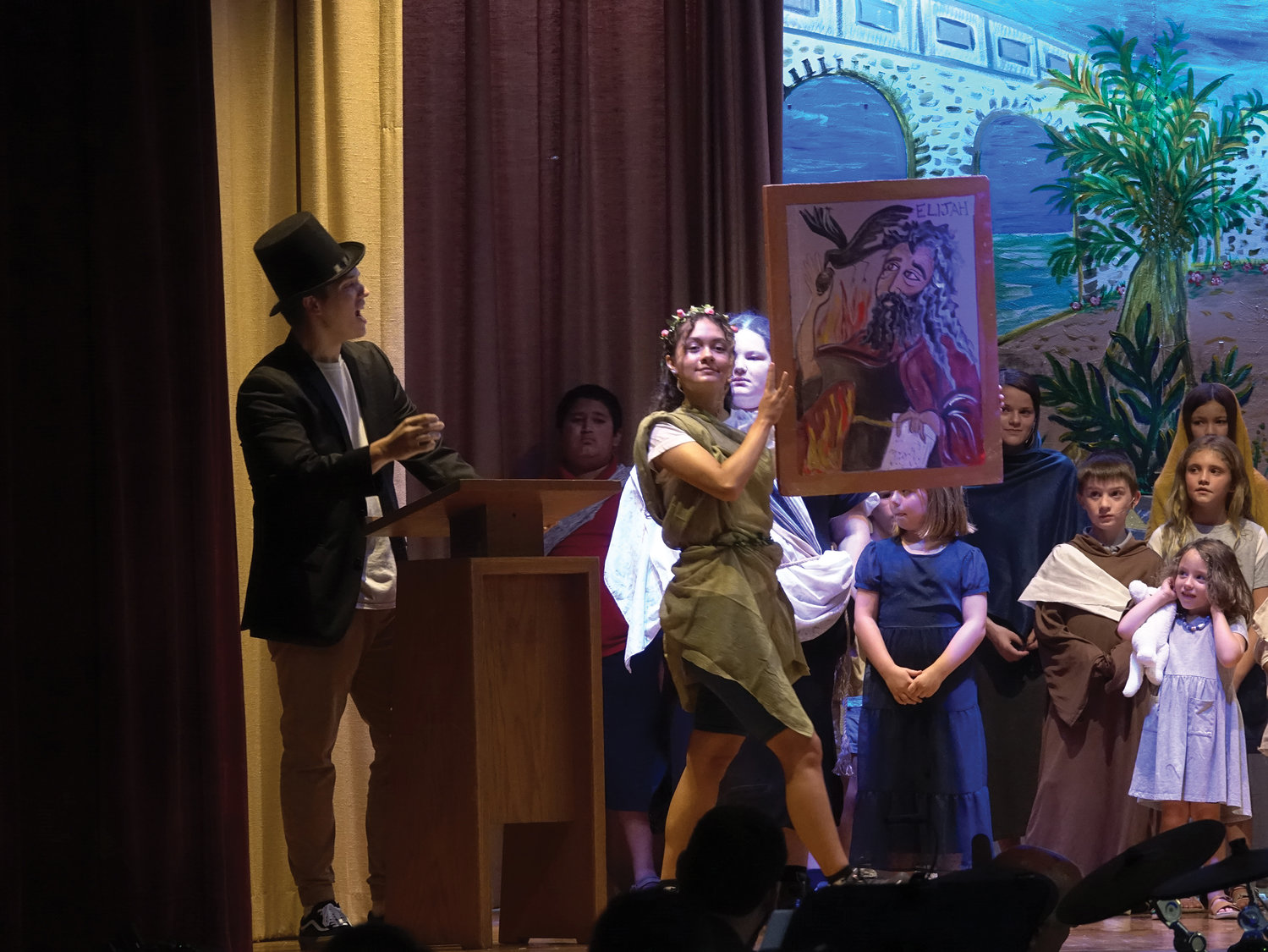 Juliana Barros holds a portrait of the Old Testament prophet Elijah during the Capuchin Youth & Family Ministries’ presentation of “Jonah and The Prophettes” Aug. 6 at St. Mary’s School in Wappingers Falls.