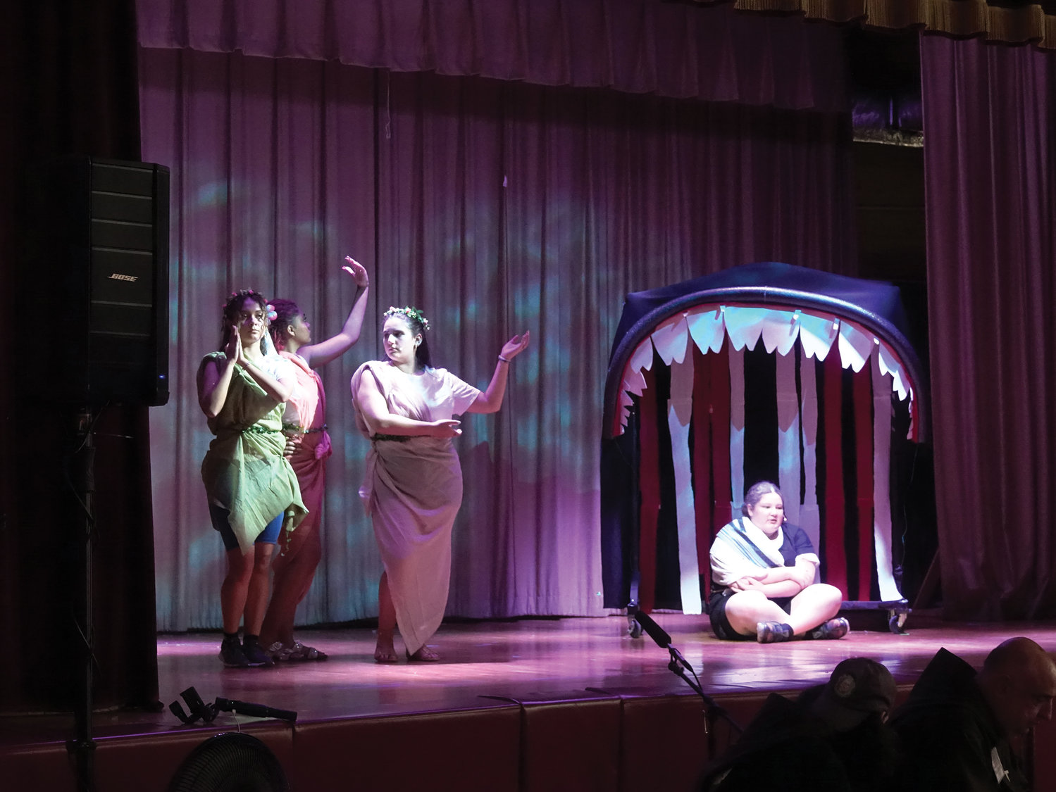 Kathleen Ramirez, playing the role of Jonah, sits in the mouth of a whale as Juliana Barros, Alexsis Romain and Stephanie Alvarez perform at left.