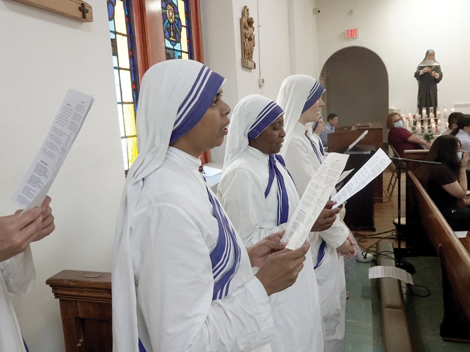 Missionaries of Charity sing during the 10 a.m. Mass Cardinal Dolan celebrated Sept. 5 at St. Rita of Cascia Church, the Bronx, in commemoration of the 25th anniversary of the death of St. Teresa of Calcutta, the order’s foundress.