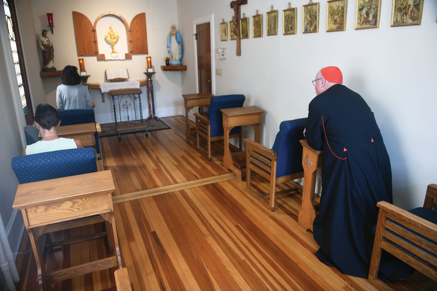Cardinal Dolan prays inside the Divine Mercy chapel before celebrating Mass.