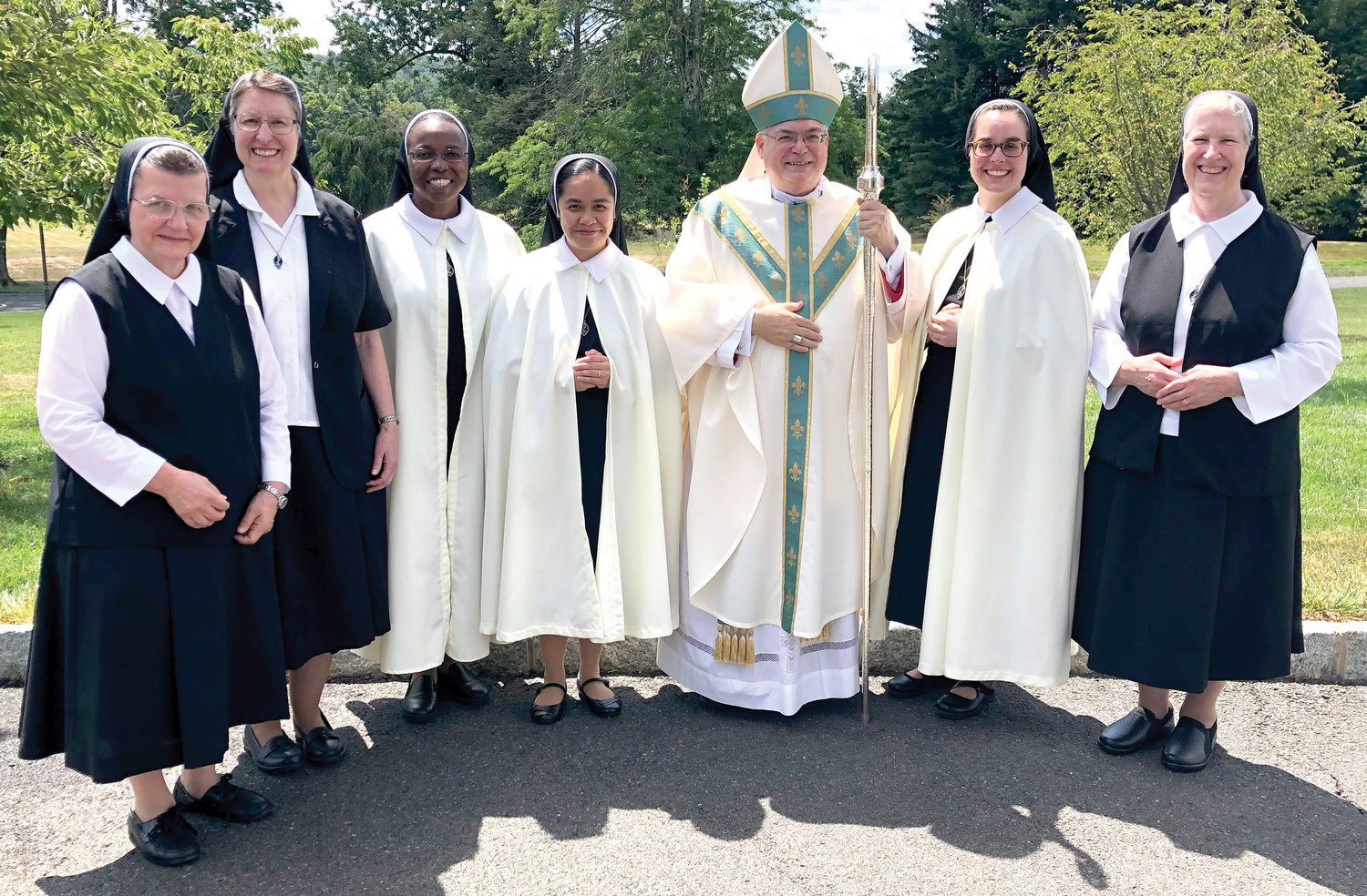 PROFESSED—From left, Sister Maria del Rosario, S.C.C., general superior; Sister Joann Marie Aumand, S.C.C., provincial superior of the Eastern Province; Sister Monique Eloizard, S.C.C.; Sister Luiza Simon, S.C.C.; Bishop Alfred A. Schlert, of Allentown, Pa.; Sister Regina Bathalon, S.C.C.; and Sister Mary Joseph Schultz, S.C.C., general councilor and tertianship director, stand outside Mallinckrodt Convent in Mendham, N.J., following the final profession of vows Aug. 15.