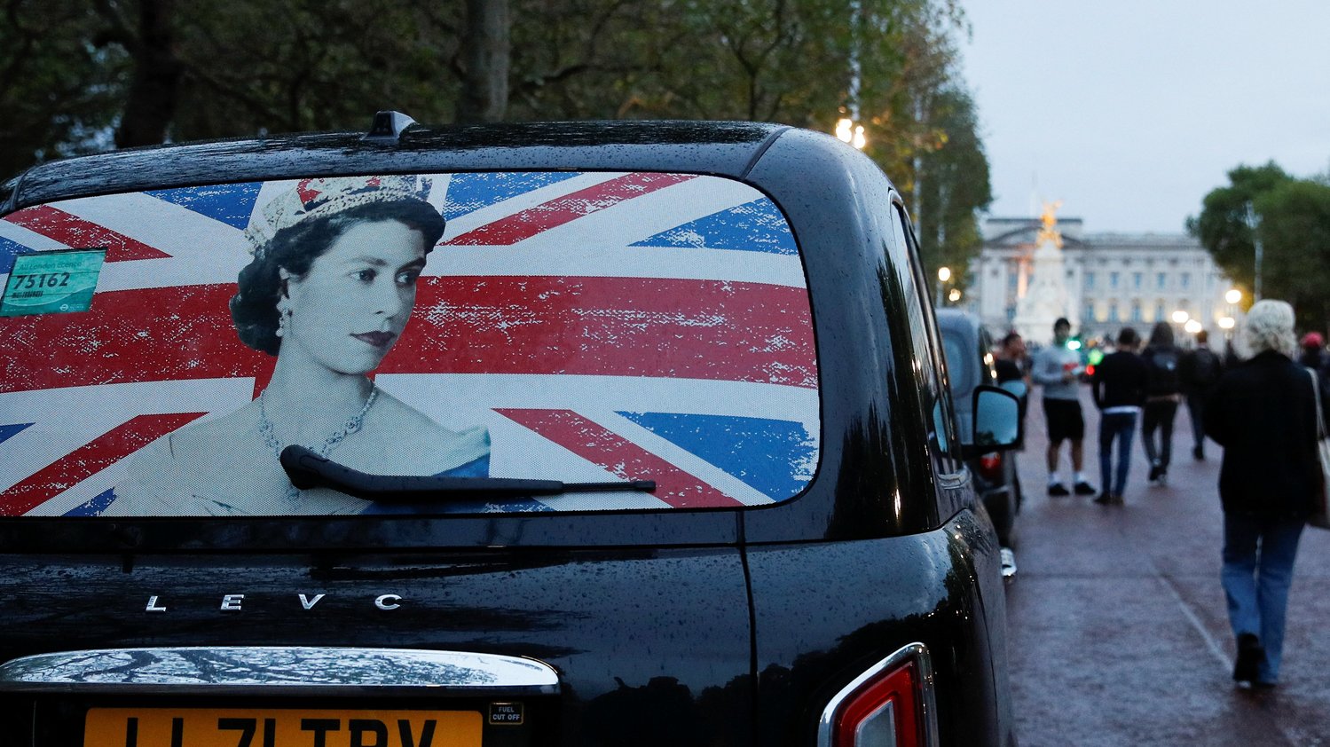 The rear window of a cab with the image of Queen Elizabeth II is pictured parked near Buckingham Palace in London Sept. 8 as people gather after the announcement that Britain’s longest-reigning monarch and the nation’s figurehead for seven decades died at the age of 96.