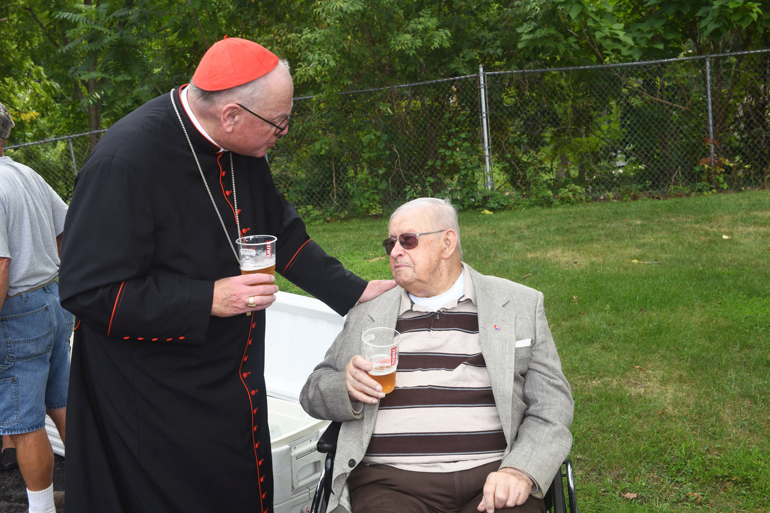 Cardinal Dolan talks to 101-year-old Paul Berish at a reception following the Mass at Immaculate Conception Church in Kingston.