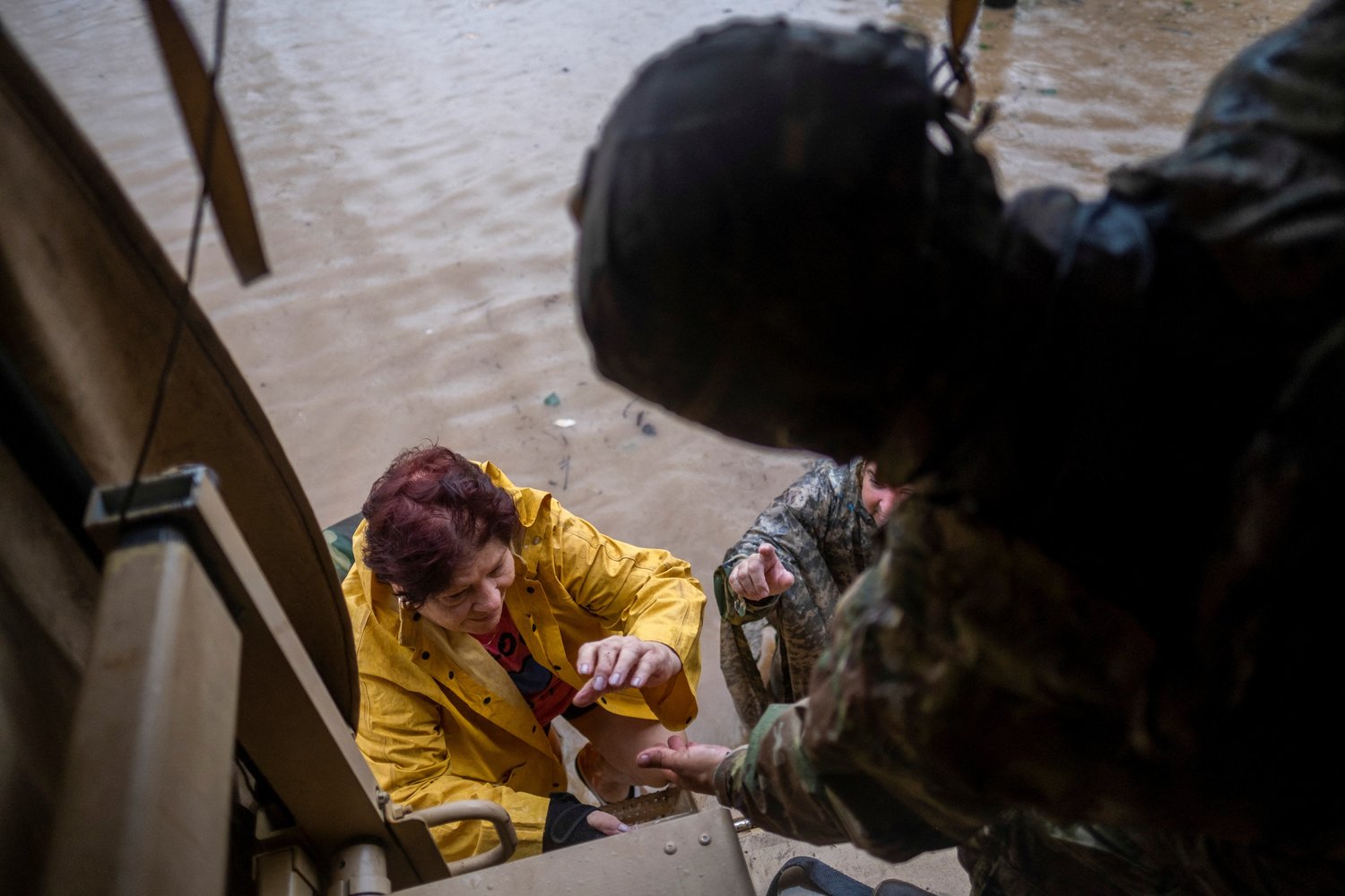 Members of the Puerto Rico National Guard rescue a woman stranded in her house Sept. 19 in the aftermath of Hurricane Fiona in Salinas, Puerto Rico.