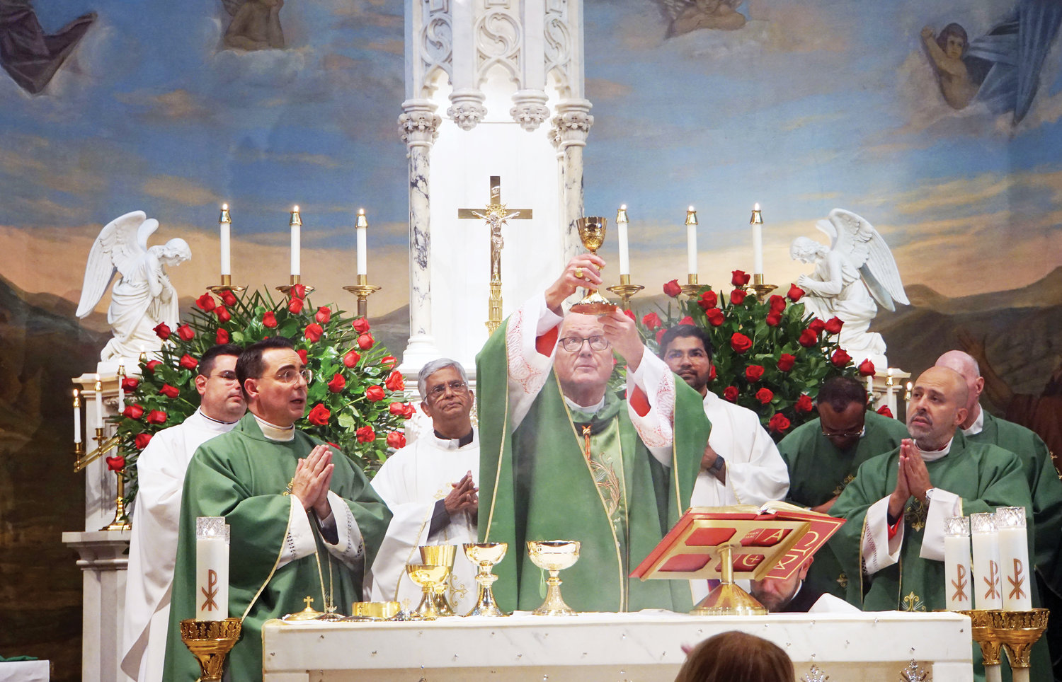 Cardinal Dolan elevates the Eucharist during the consecration at the Oct. 1 Mass celebrating the 100th anniversary of Our Lady of Pompeii in Dobbs Ferry.
