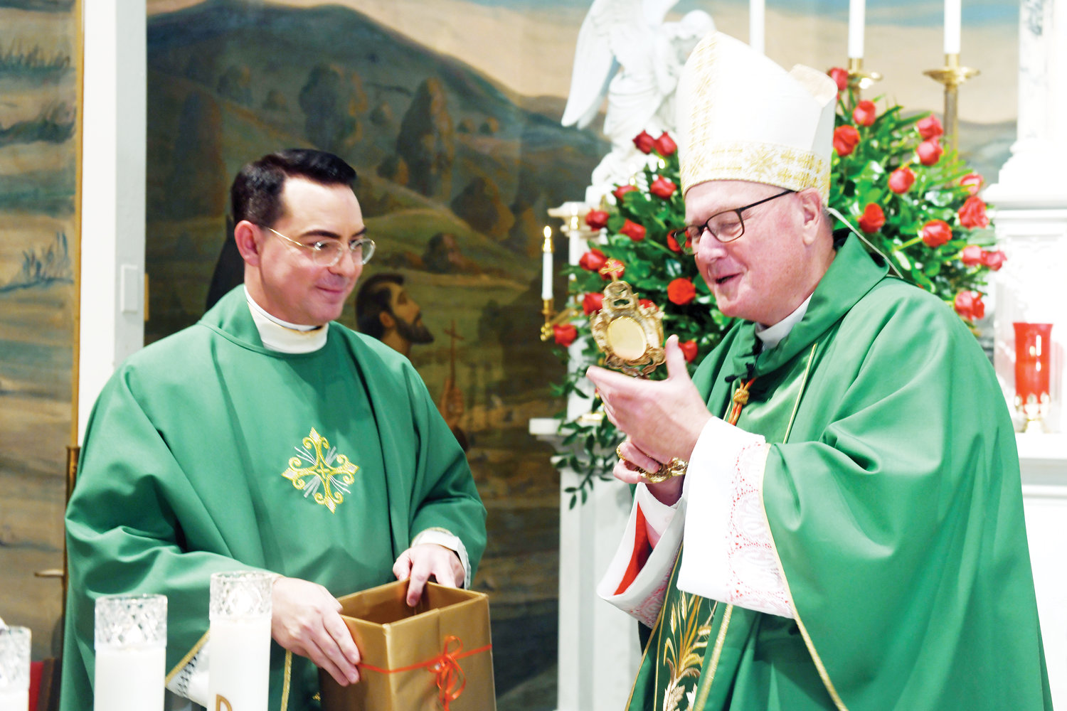 Father Chris Monturo, pastor of Sacred Heart-Our Lady of Pompeii parish, presents Cardinal Dolan with a relic of Mother Cabrini, a piece of the saint’s habit.