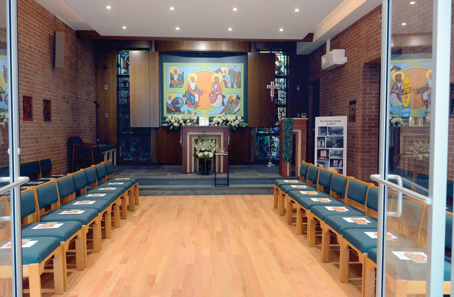 Before the liturgy at St. Monica’s Church, the cardinal blessed the renovated parish center, formerly a convent, which includes the 35-seat St. Elizabeth of Hungary Chapel. The icon behind the altar depicts scenes from the life of St. Elizabeth of Hungary. Father Donald Baker, the pastor, designed and painted the icon in collaboration w