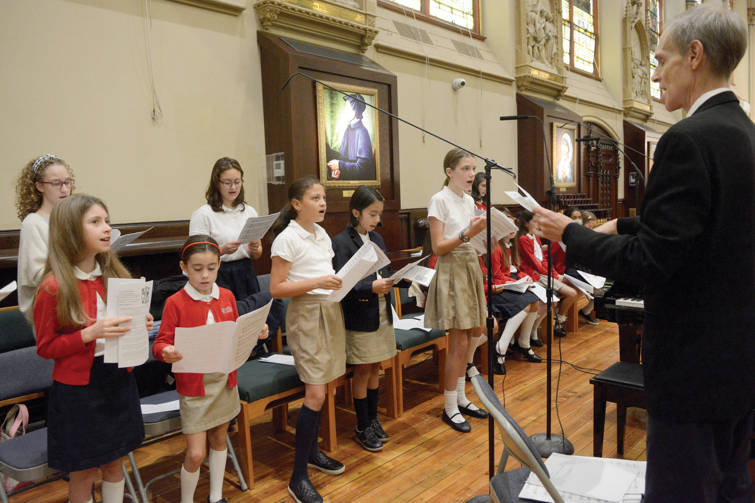 Choristers from the St. Stephen of Hungary School choir lift their voices in song.