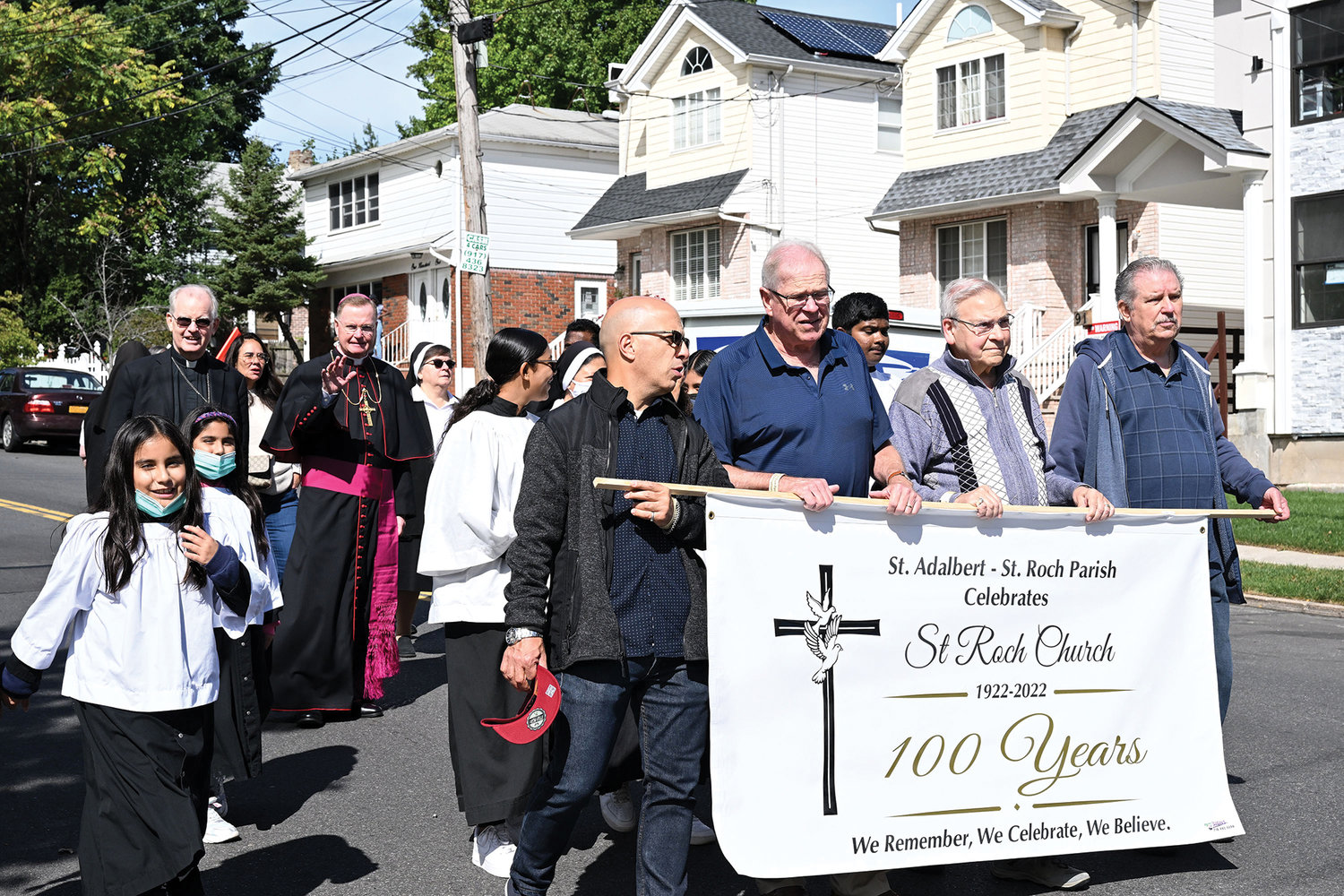 Bishop Whalen waves while strolling on Walker Street next to Auxiliary Bishop Peter Byrne, episcopal vicar for Staten Island, in the pre-Mass procession.