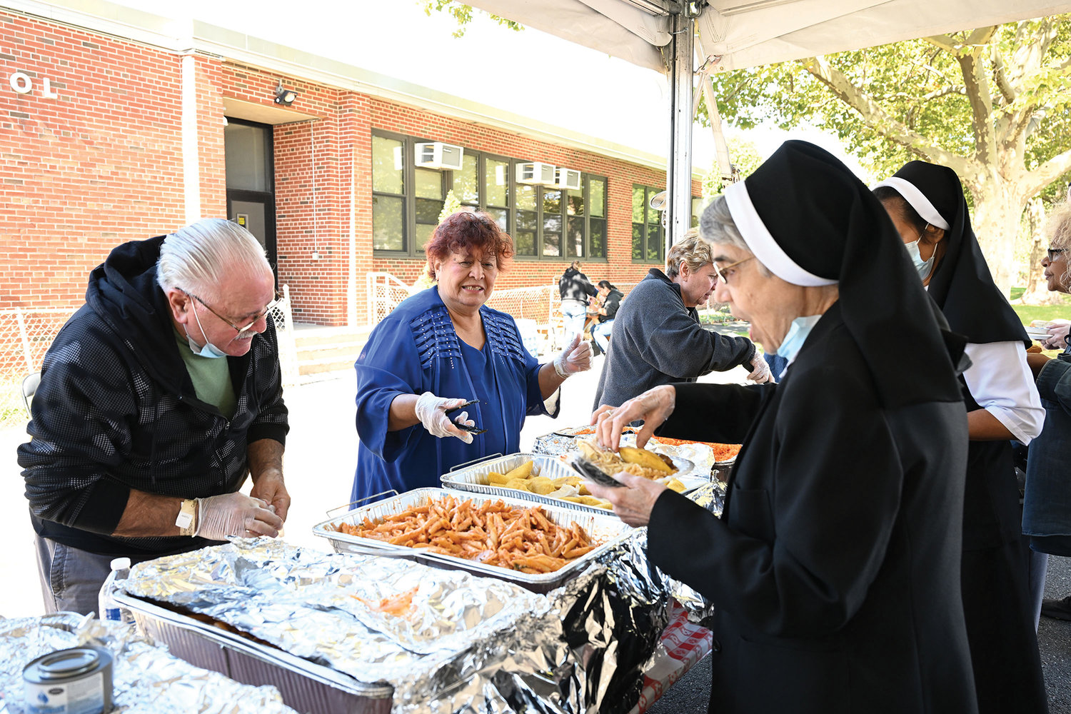 Sisters of St. John the Baptist enjoy the food at the picnic after Mass.