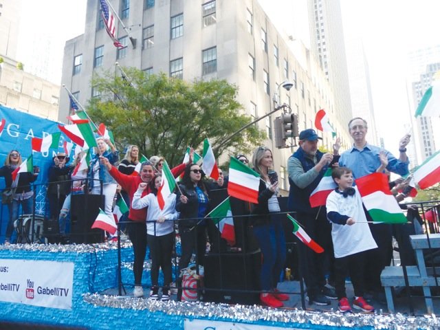 People wave Italian flags on a float along Fifth Avenue in Manhattan Oct. 10 during the 78th annual Columbus Day Parade.